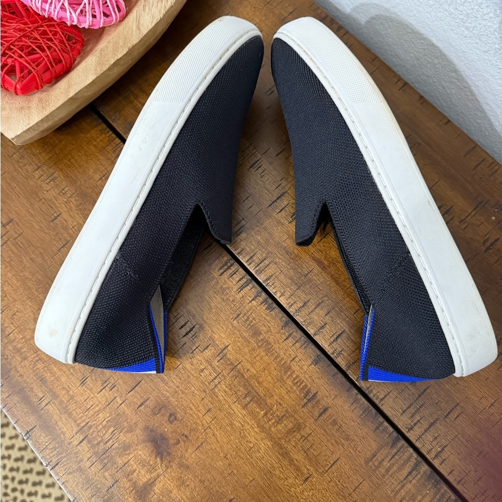 Rothy's The Original Slip On Sneaker in black solid with blue trim - Picture 4 of 8